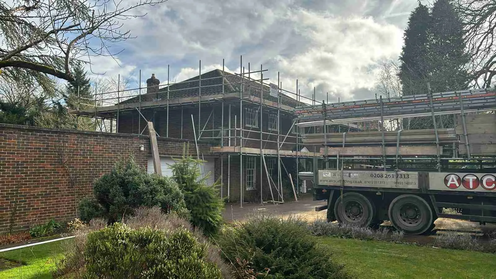 ATC Scaffolding truck beside a house with full scaffolding erected for roofing works